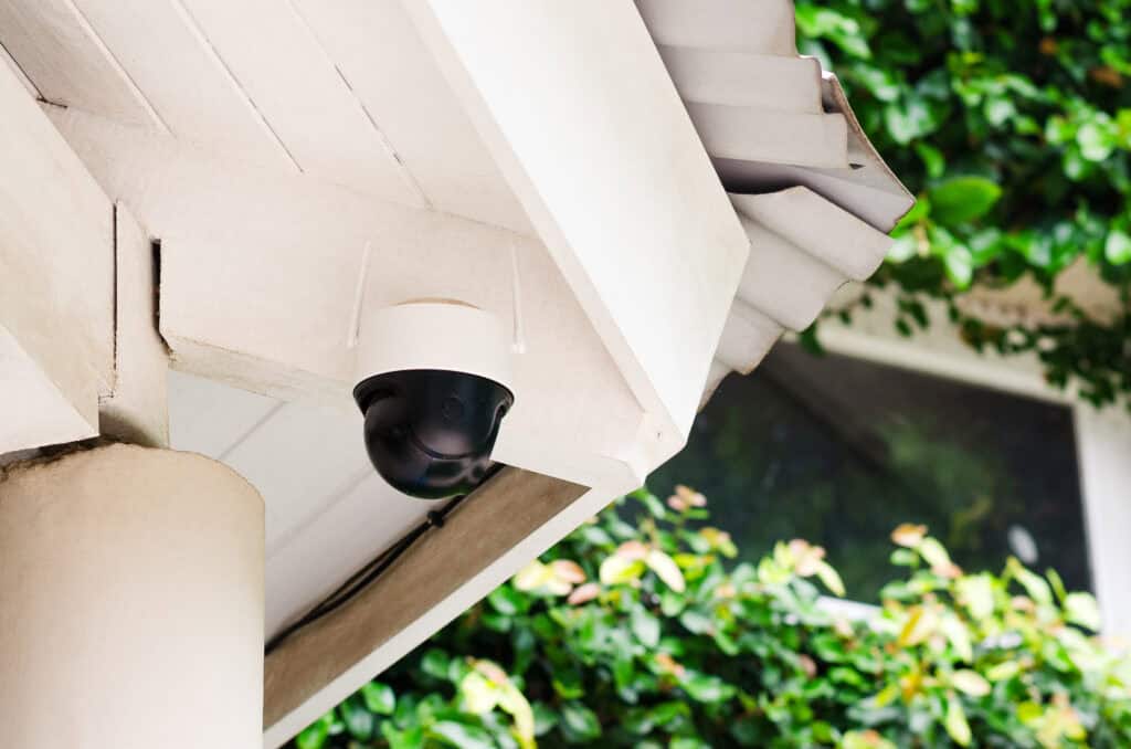 Close-up of a security camera mounted on a house exterior, highlighting professional installation for enhanced home security in Chicago.