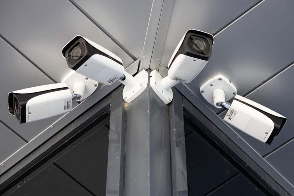 Multiple security cameras installed on a building corner for surveillance in Chicago.