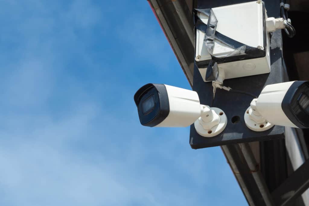 Security cameras mounted on a building corner for surveillance in Chicago.